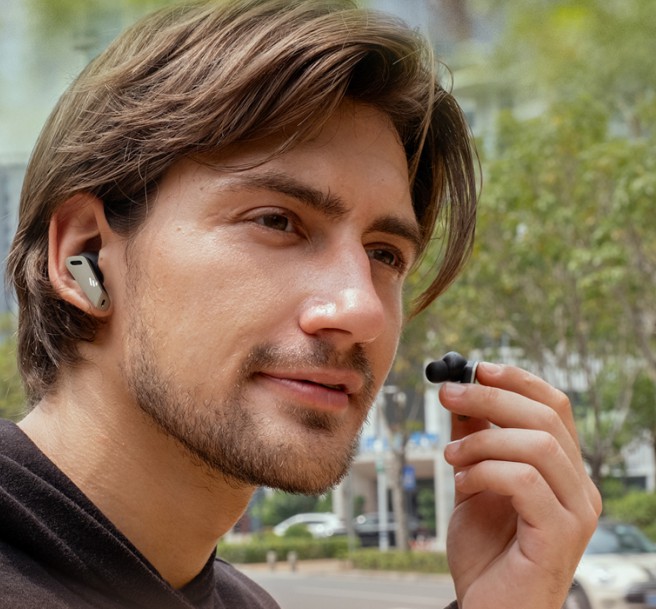 the man is going to wear the edifier earbuds