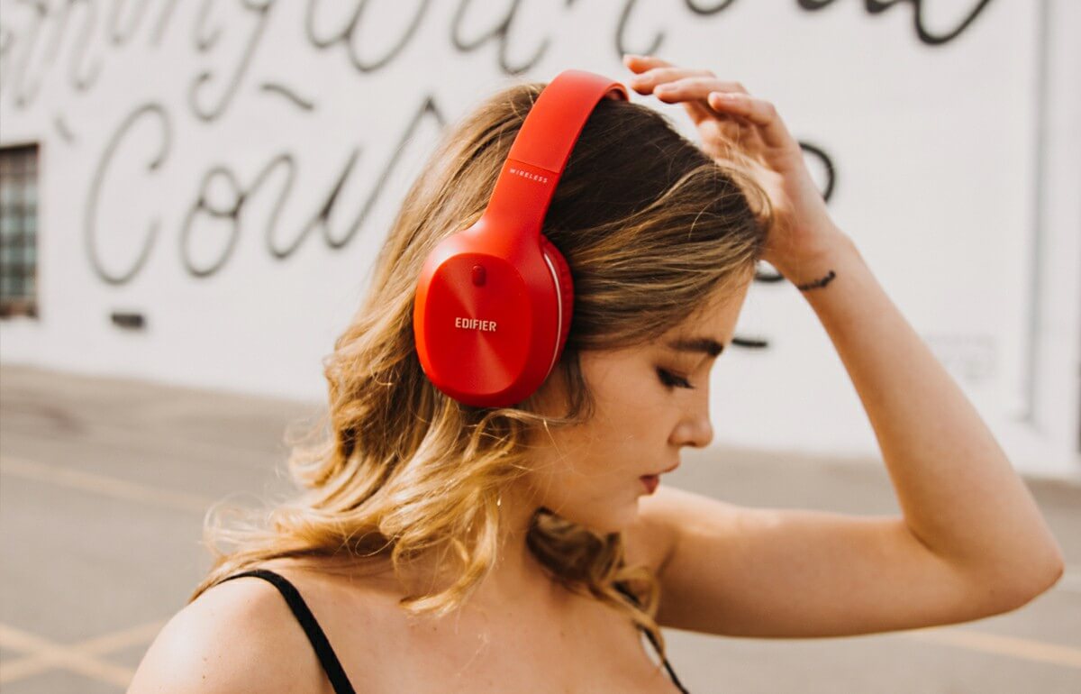 A woman wearing Edifier Red headphones