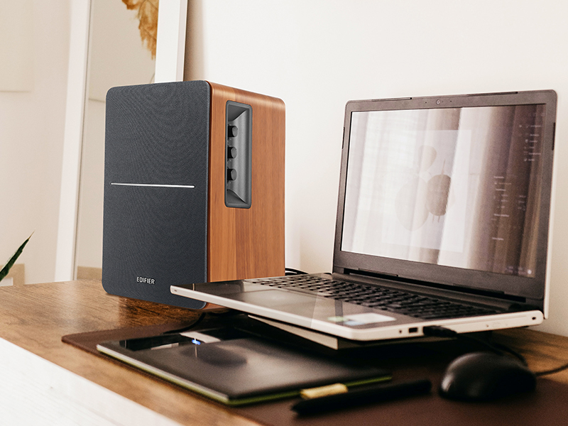 brown bookshelf speaker connected to the laptop